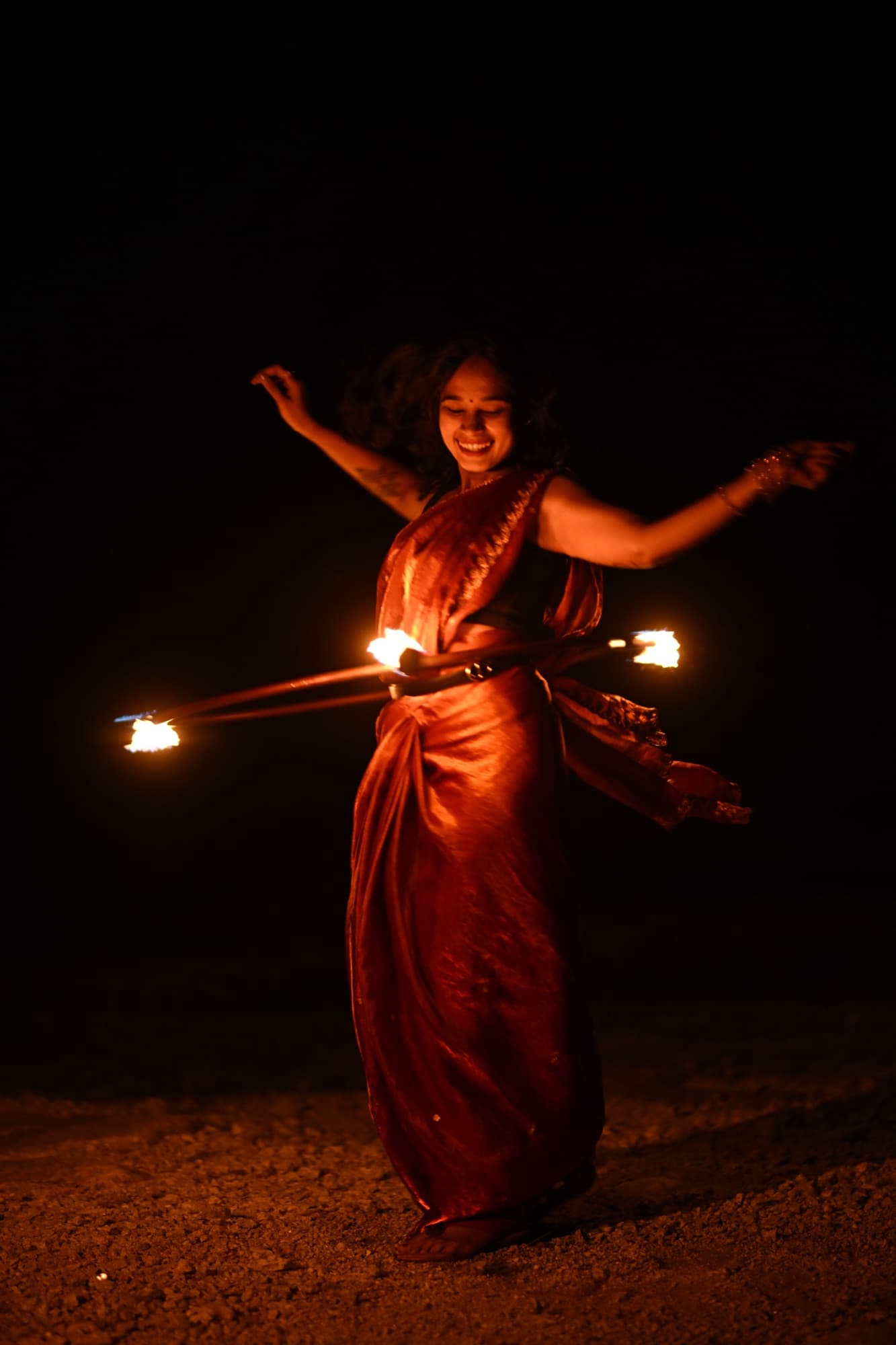 Devina performing a fire hoop routine at night